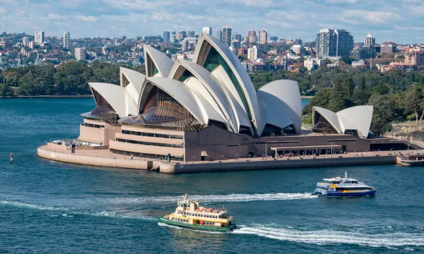 Sydney Opera House and harbour ferries on a sunny day – Australia cruises – Luxury Sassy Cruises