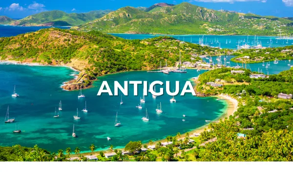 Aerial view of a lush green bay with yachts anchored in clear Caribbean waters, Antigua.