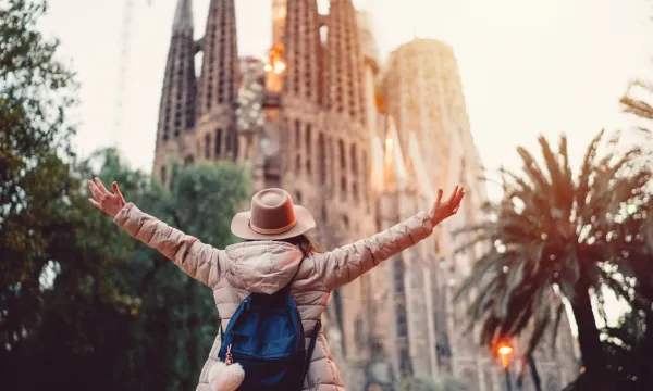 Traveller embracing the view of La Sagrada Família in Barcelona at sunrise – capturing the cultural magic of a Mediterranean cruise stop in Spain.