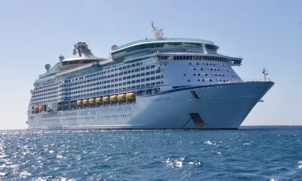 A luxury cruise ship sails through Norway’s spectacular Geirangerfjord, surrounded by towering cliffs, cascading waterfalls, and the timeless beauty of Northern Europe’s wild landscapes.