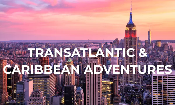A vibrant sunset over the New York City skyline, with the Empire State Building prominently featured and city lights beginning to glow. White text reads "Transatlantic & Caribbean Adventures."