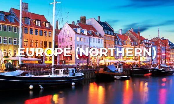 Colourful harbourfront buildings and sailboats at twilight in Copenhagen, Denmark – perfect setting for a Northern Europe Azamara cruise.