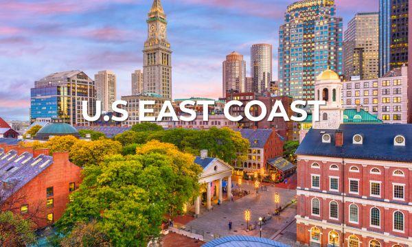 Scenic view of historic downtown Boston with Faneuil Hall and the Custom House Tower under a vibrant sunset sky – ideal starting point for a U.S. East Coast Azamara cruise.
