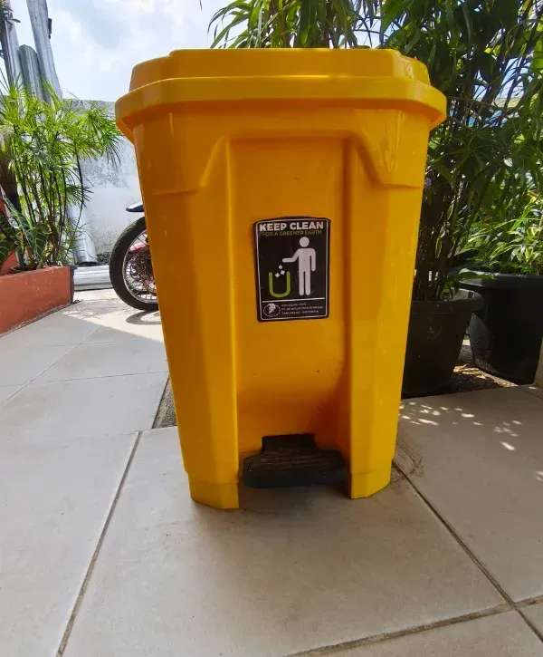 Yellow trash can freshly pressure washed