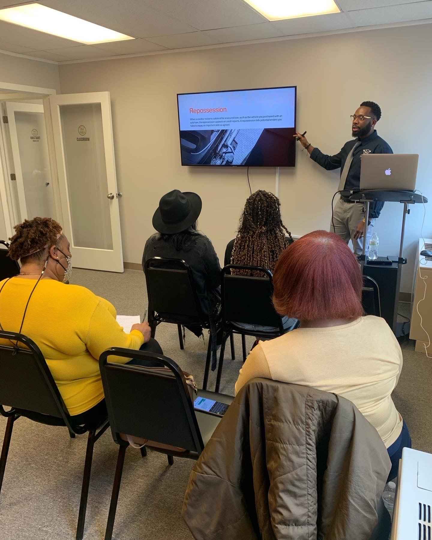 Financial Fit Club classroom presentation on repossession and loan management, attendees learning credit basics