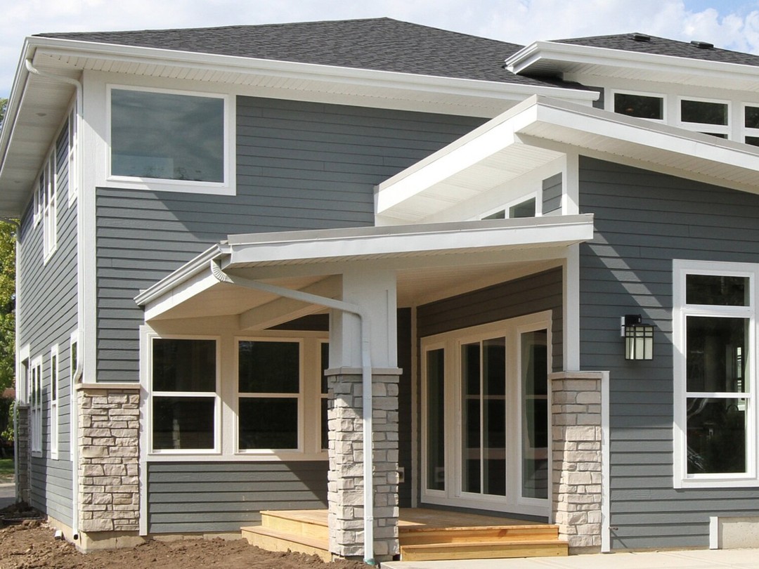 two men working on the roof of a house