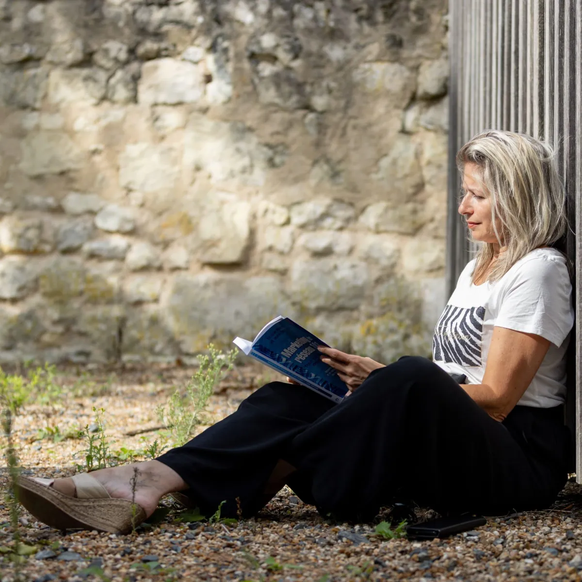 a woman standing on a bridge with her arms crossed