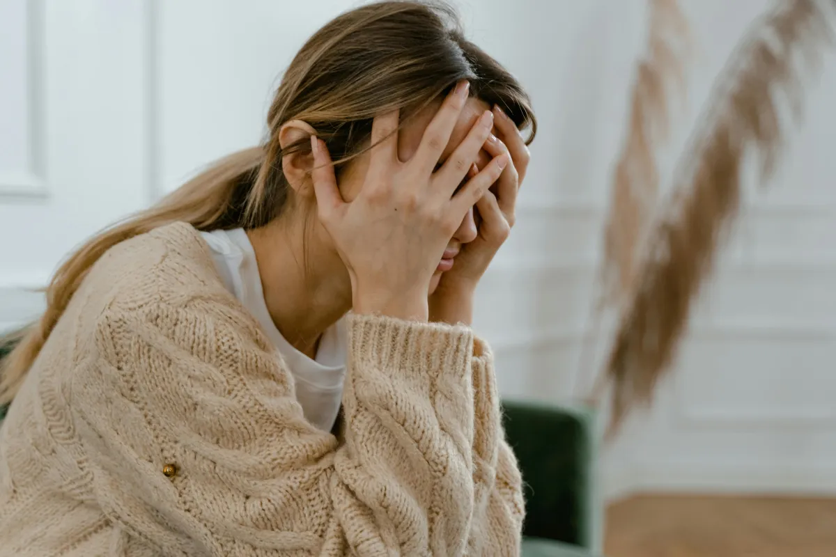 Stressed woman experiencing menopause and perimenopause symptoms – hormone depletion linked to hot flashes, weight gain, insomnia, anxiety, and decreased libido