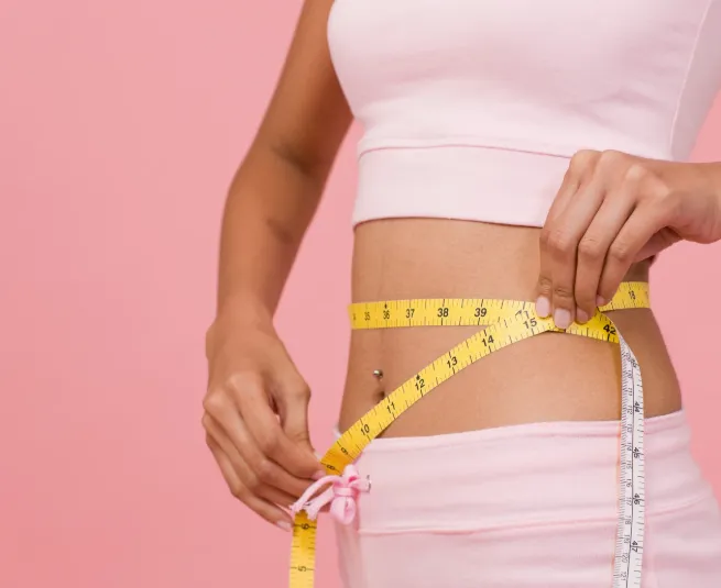 Woman measuring waistline – benefits of medically supervised prescriptions with body composition analysis at Hormone Treatment Centers