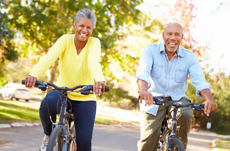 Overland Park couple enjoying bike ride after platelet-rich plasma (PRP) therapy for joint pain and tissue regeneration at Hormone Treatment Centers in Kansas.