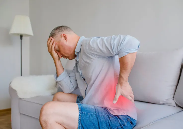 Overland Park man suffering from back pain before receiving testosterone replacement therapy for chronic pain relief at Hormone Treatment Centers in Kansas.