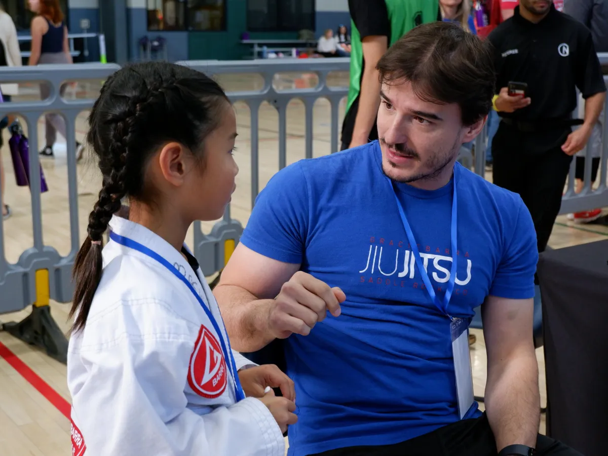Image of children practicing Brazilian Jiu Jitsu on a mat.