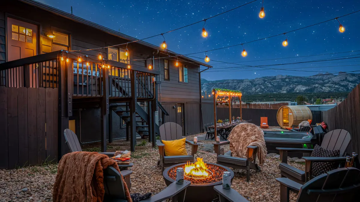 Candlelit covered garden veranda with artisanal ceramics, custom teak dining surfaces, and tropical flora