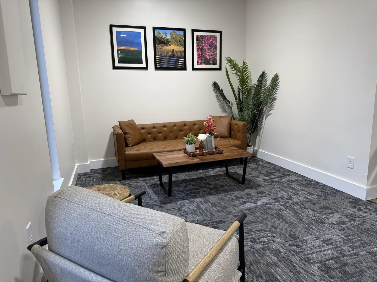 black and brown wooden table near blue padded chair