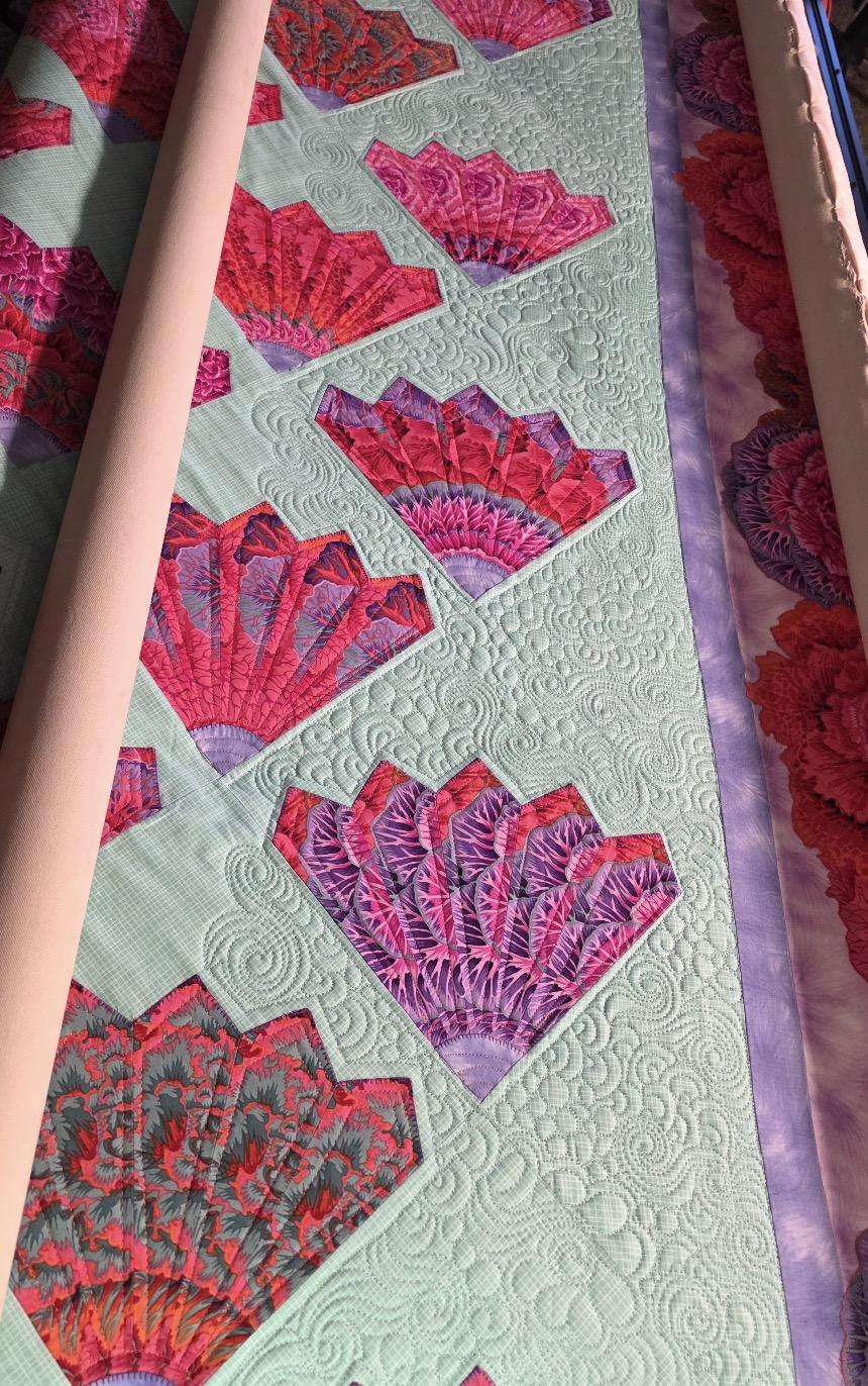Cinematic shot of colorful thread on a longarm machine