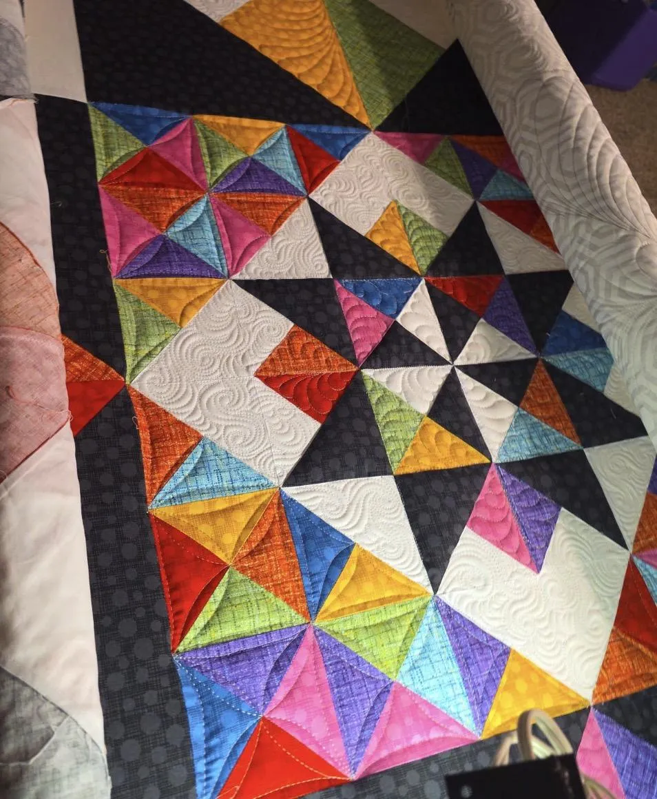 Cinematic shot of colorful thread on a longarm machine