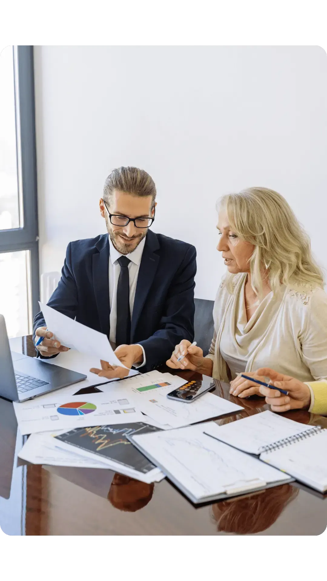 man and woman looking through some reports in an office