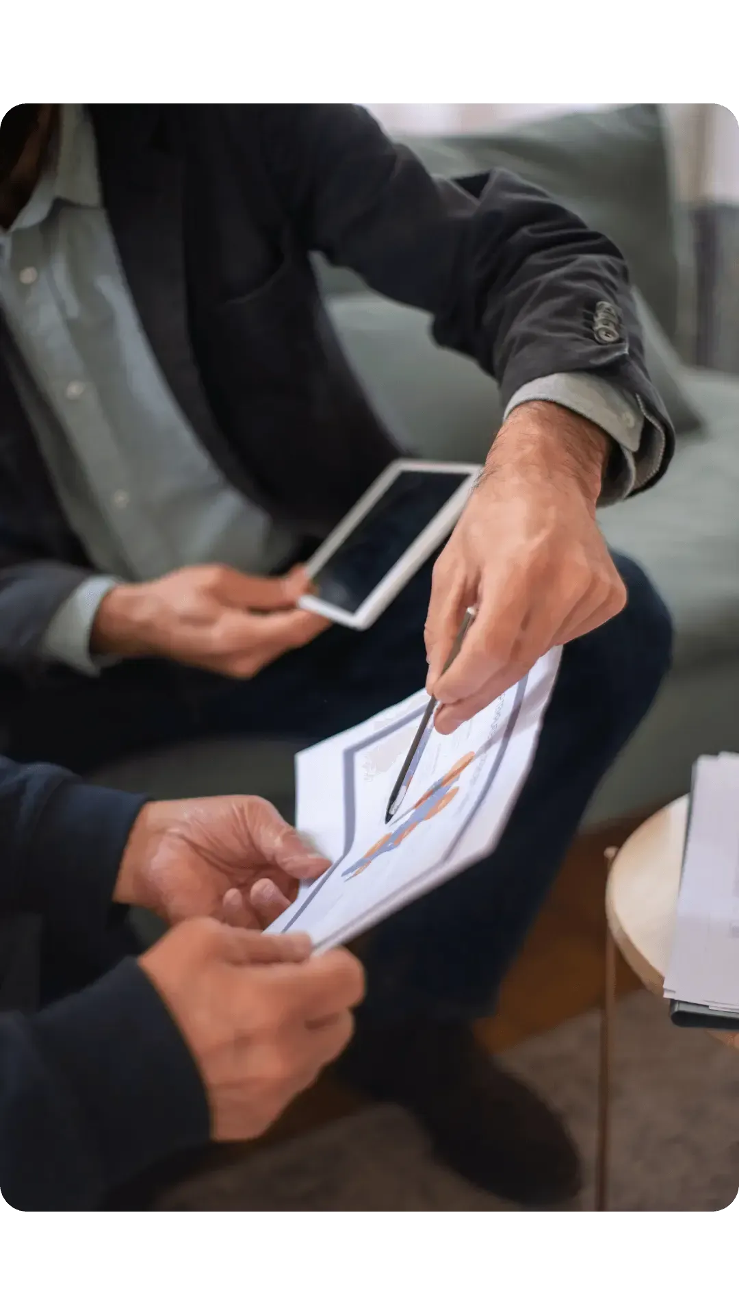 hands of two men analysing some documents