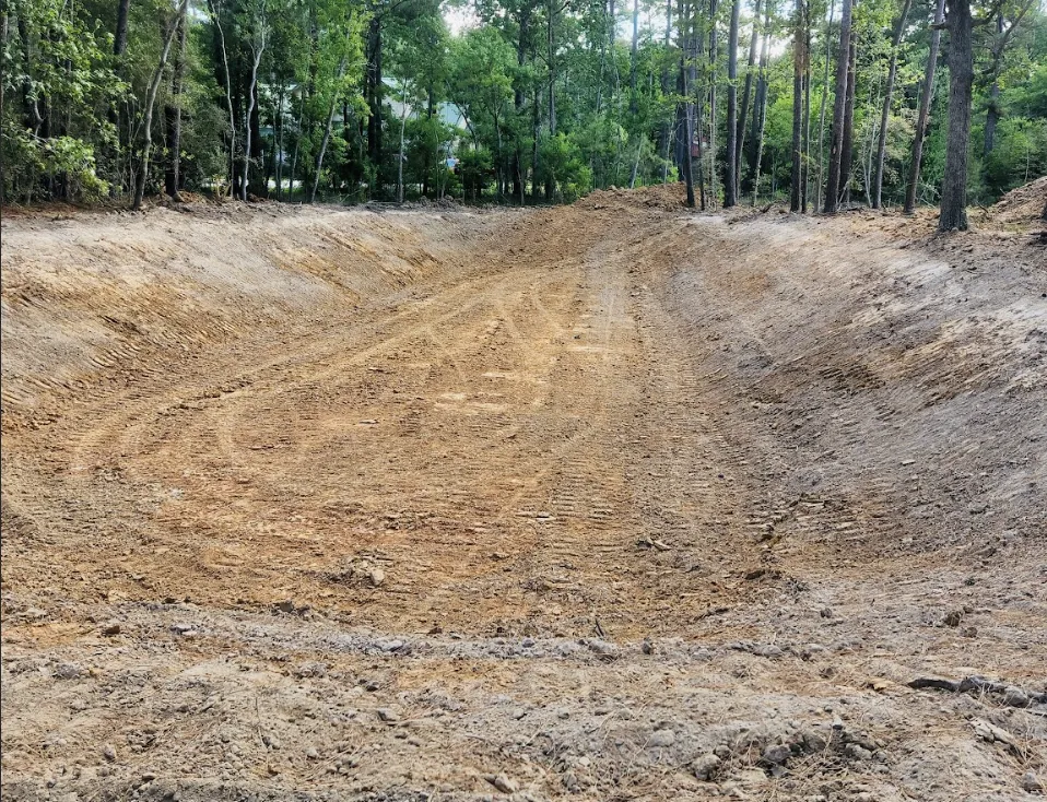 orange and white excavator on brown ground during daytime