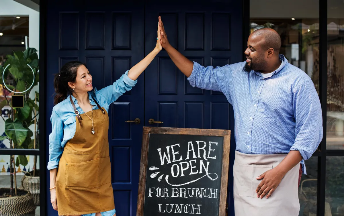 man and woman high fiving