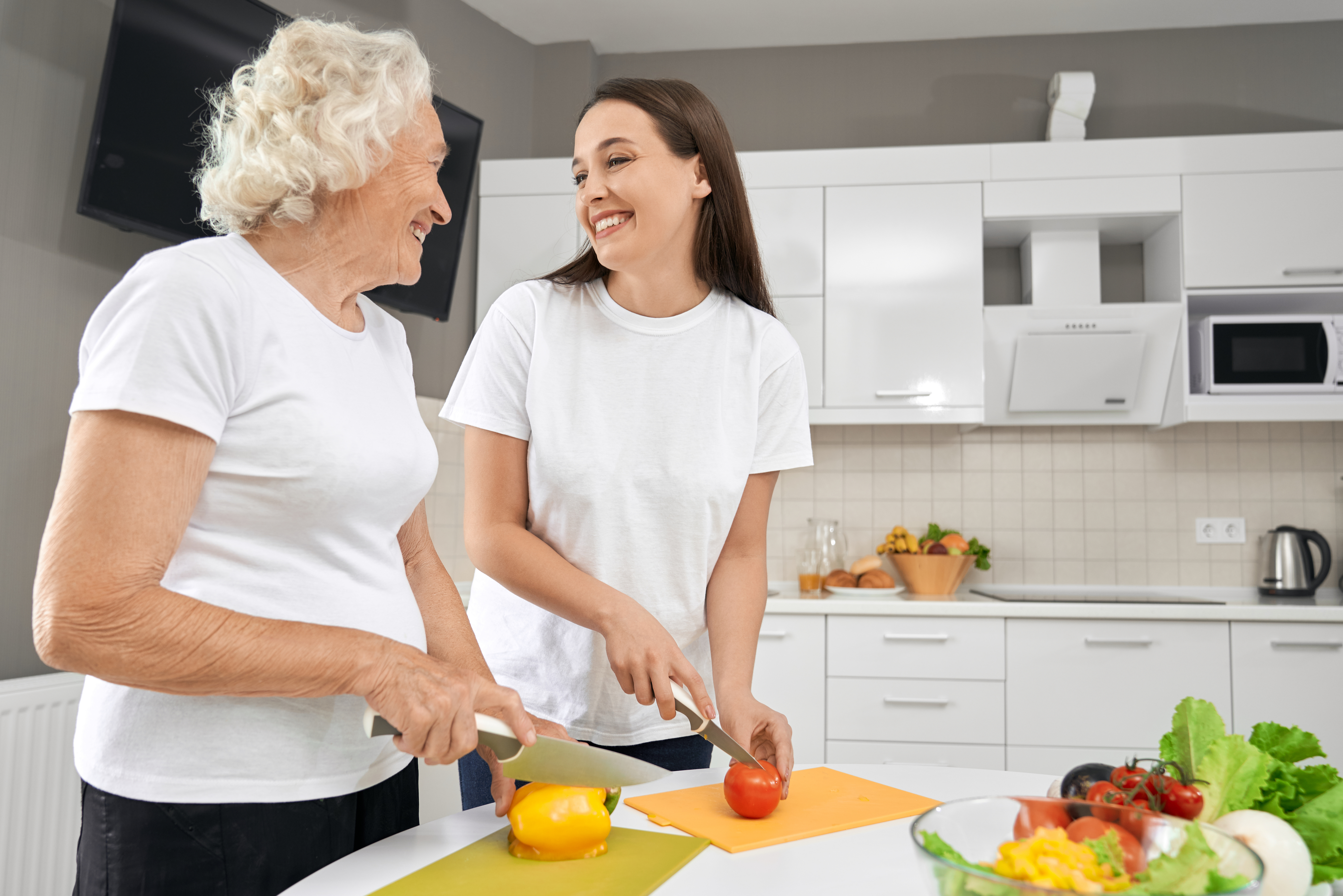 Three women interacting indoors with soft lighting.