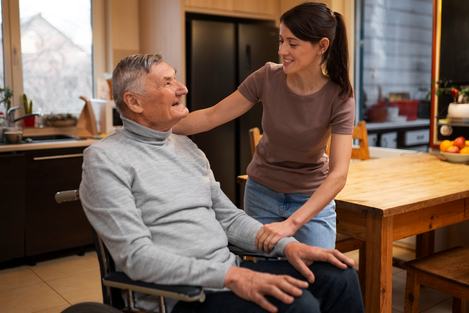 Nurse smiling with elderly patient in room