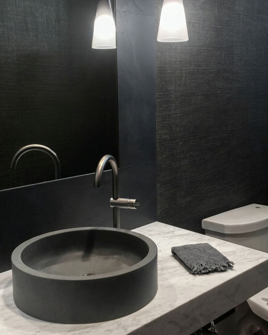 Moody powder room with custom Italian round black stone vessel sink, floating marble countertop, and pendant lighting, Bellevue