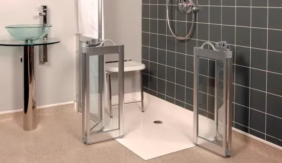 Modern low-threshold shower with grab bars and seating, replacing tall tubs that pose slip risks in busy family bathrooms.