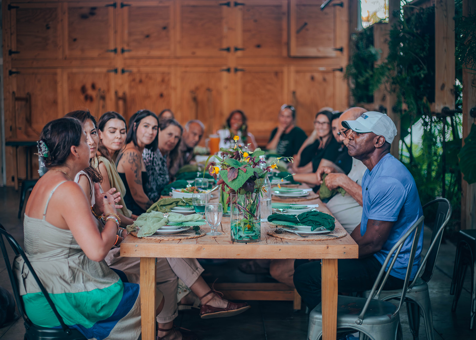 A woman meditates peacefully in the lotus position on a cliff edge, overlooking layers of misty mountains.