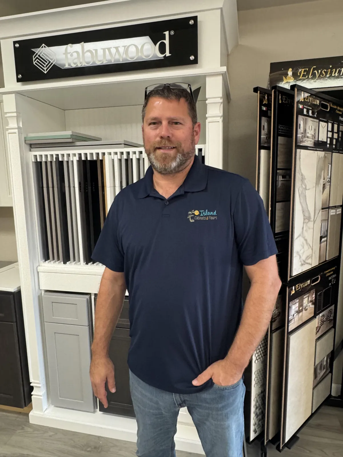 Island Cabinets and Floors owner Shane Dooley portrait photo with flooring options in the background