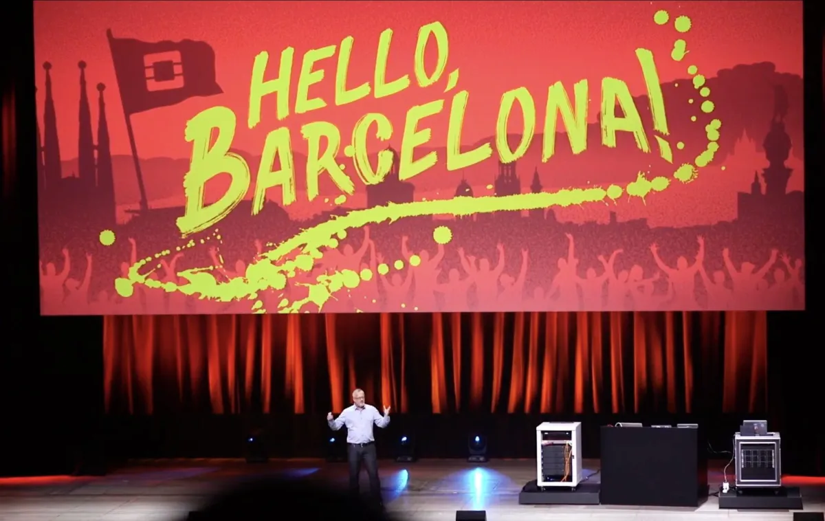image of a man on stage presenting with a slide that says hello barcelona