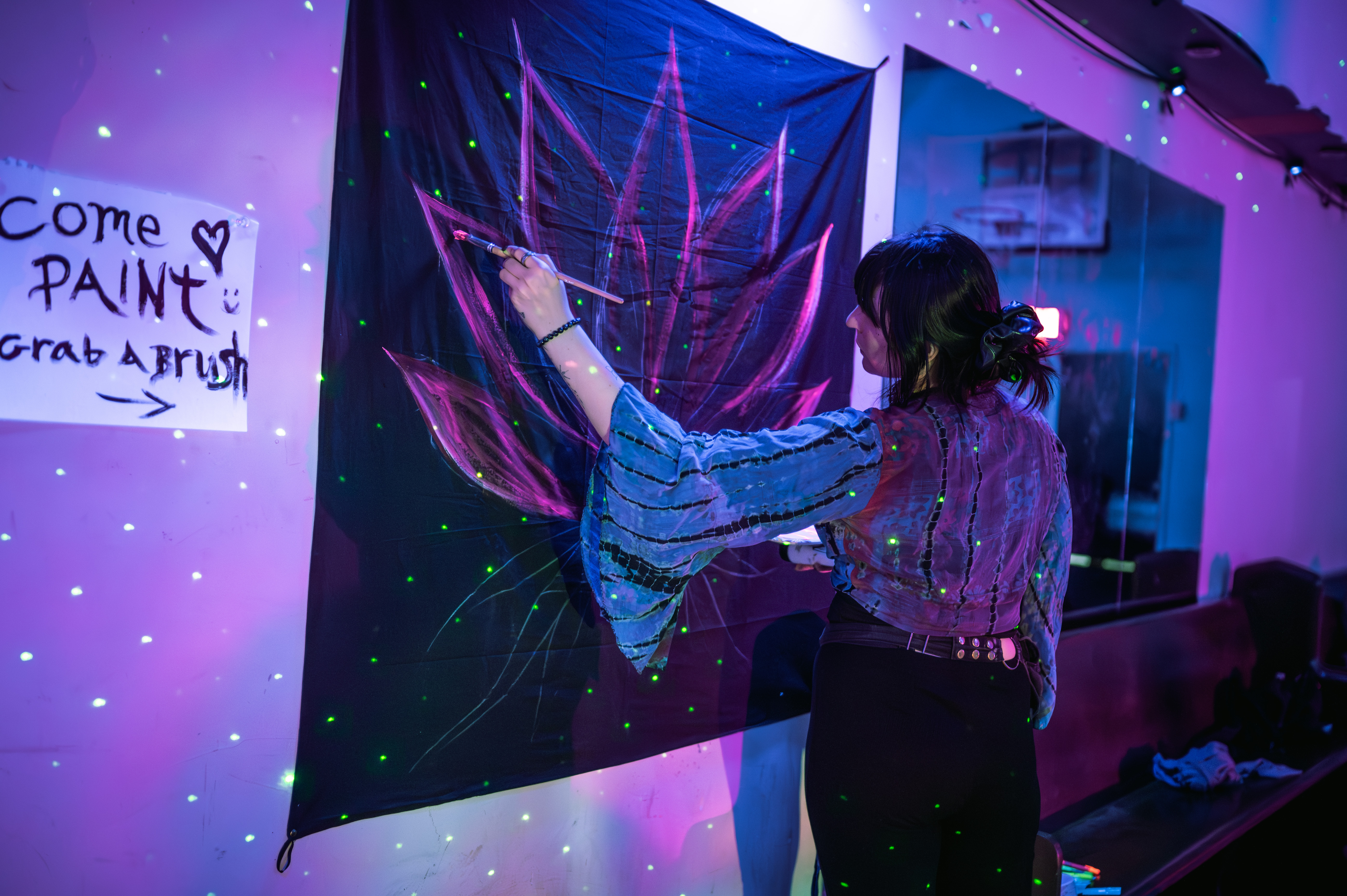 Participants laying under ambient lights during a sound bath