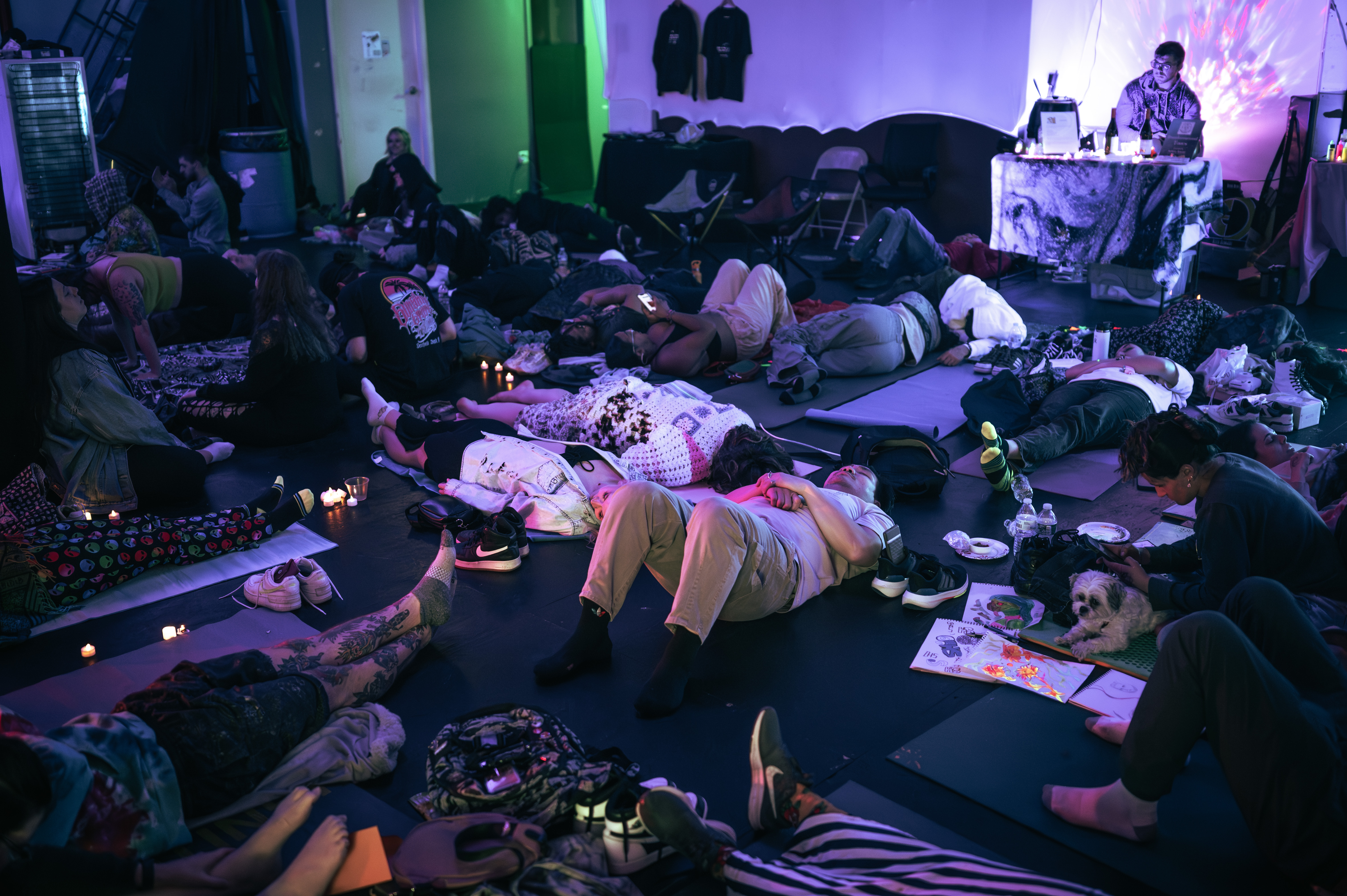 Immersive Sound Bath Sunday experience with participants in a dark, glowing room