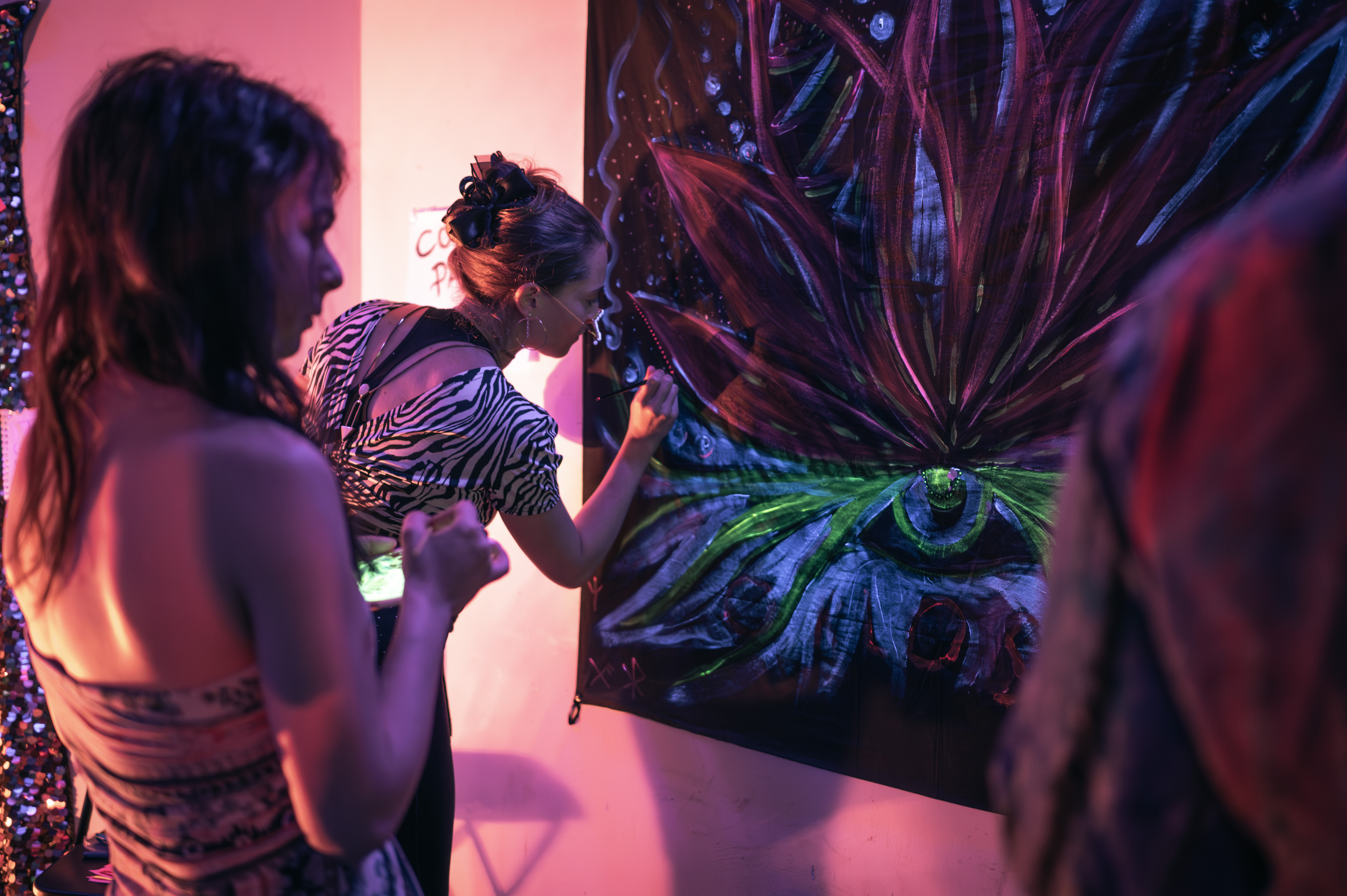 Live musician playing bass in a dimly lit immersive space