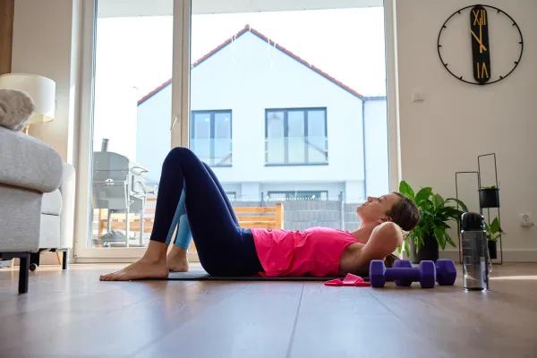 Person looking frustrated trying to do crunches on floor