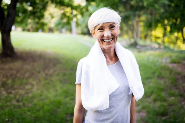Vibrant, active older adult walking confidently with Abdomen Balls™ in beautiful outdoor setting