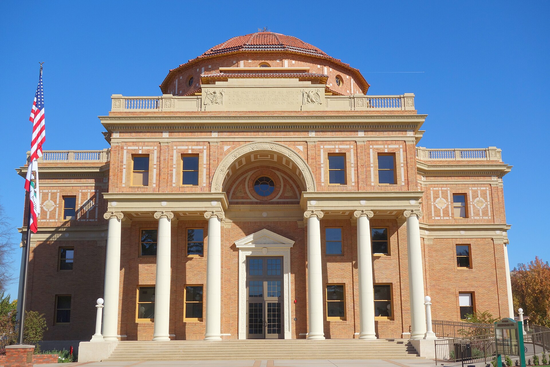 Historic Atascadero City Hall, an Italian Renaissance-style brick building in downtown Atascadero, California, viewed from the front on a sunny day.