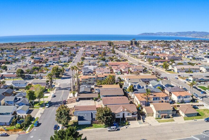 Homes in the Grover Heights area of Grover Beach, California, with residential streets, mature landscaping, and the Pacific Ocean in the distance.