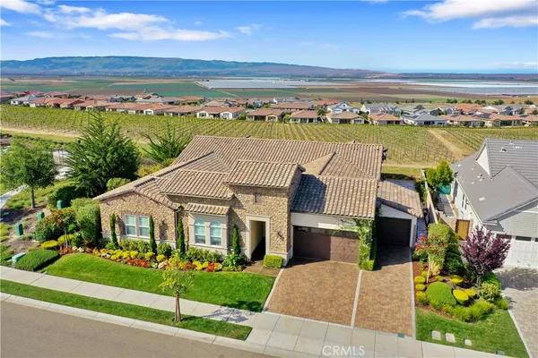 Luxury home in Nipomo, California, with landscaped grounds overlooking green fairways and mature trees.