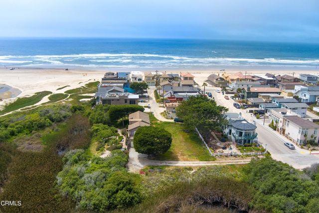 Luxury beachfront homes in Oceano, California, along the sandy coastline with views of the Pacific Ocean.