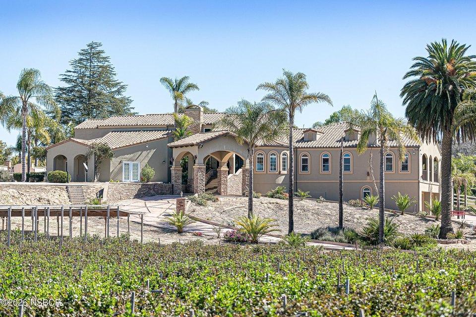 Upscale home in Santa Maria, California, with Mediterranean-style architecture, landscaped grounds, and views of a green golf course.