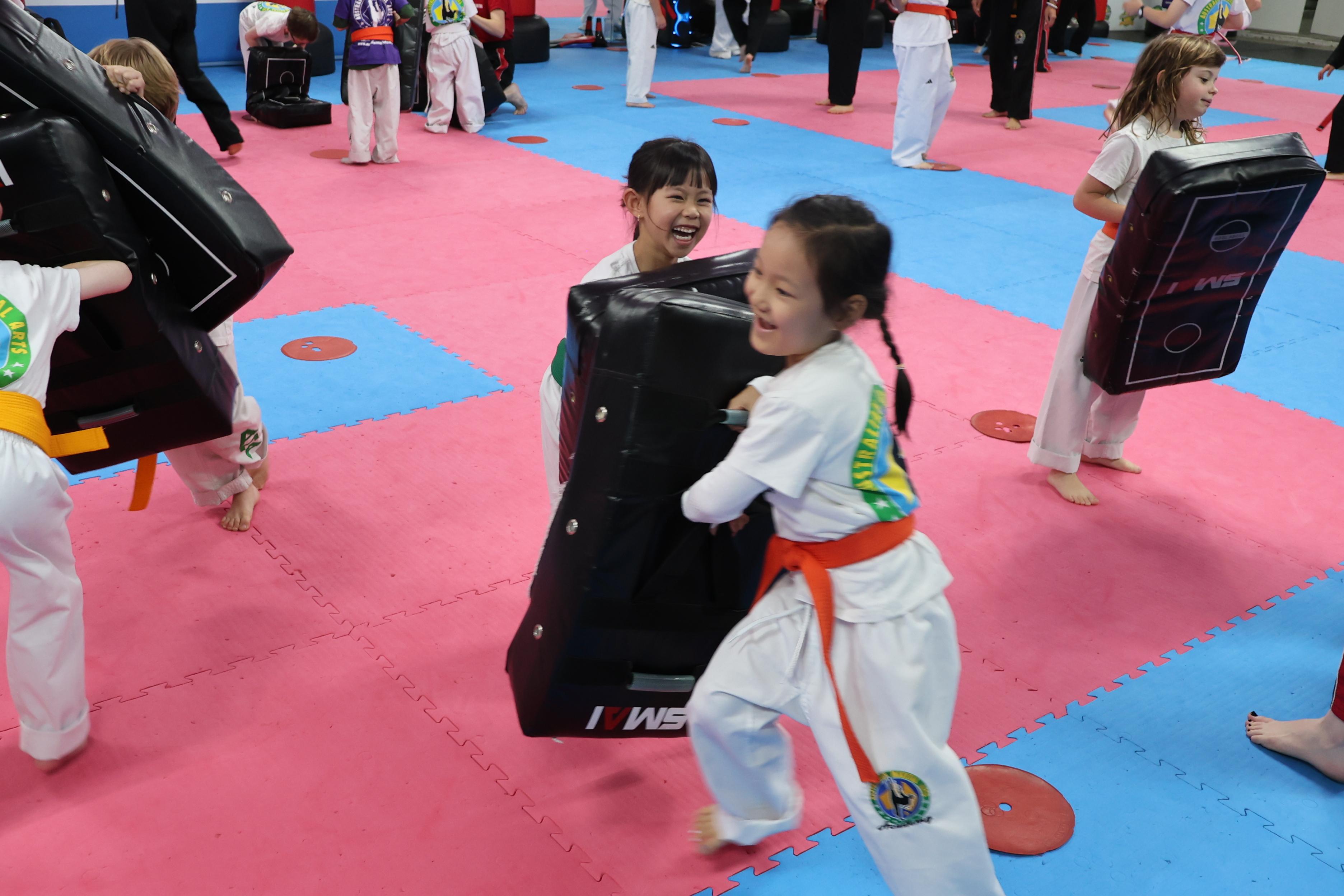 Young students training with pads in class