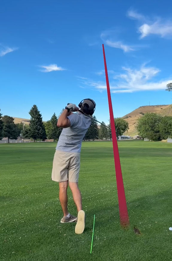 A man swinging a golf club on a golf course