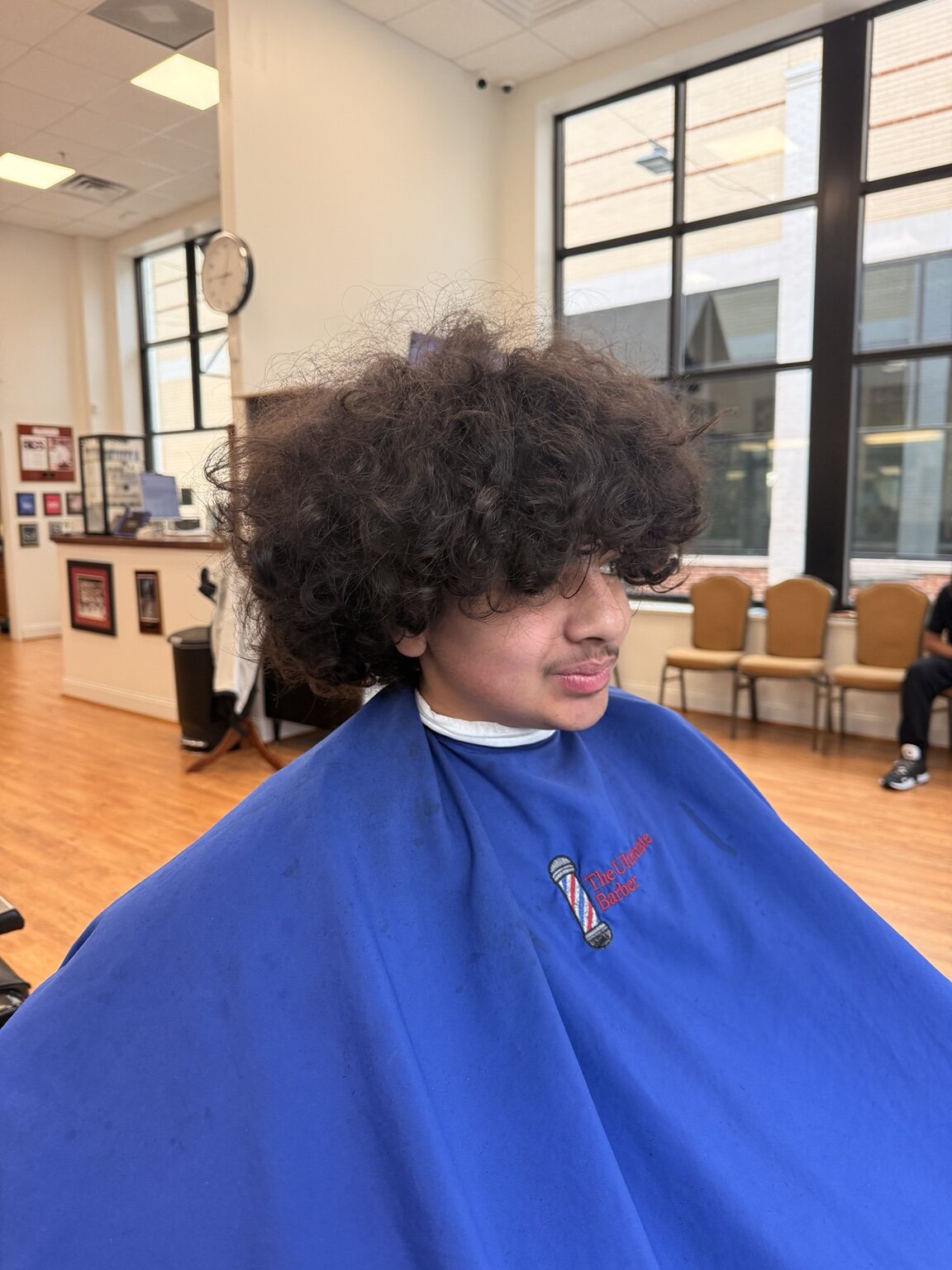 Curly hair before a fade haircut at The Ultimate Barber in Alexandria