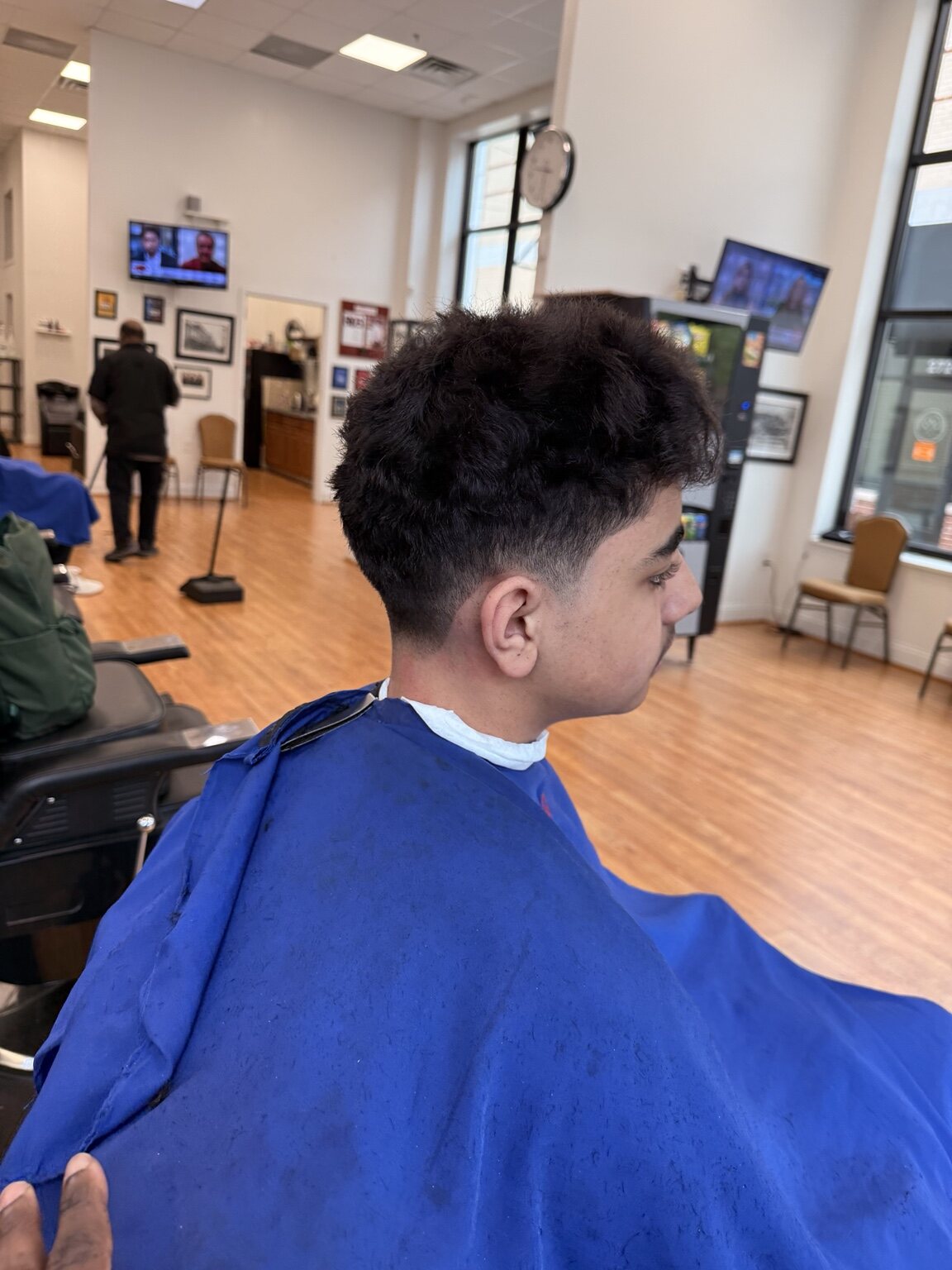 Finished curly taper fade haircut at The Ultimate Barber in Alexandria