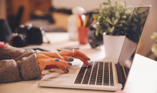 Woman Typing on a Laptop for High Level