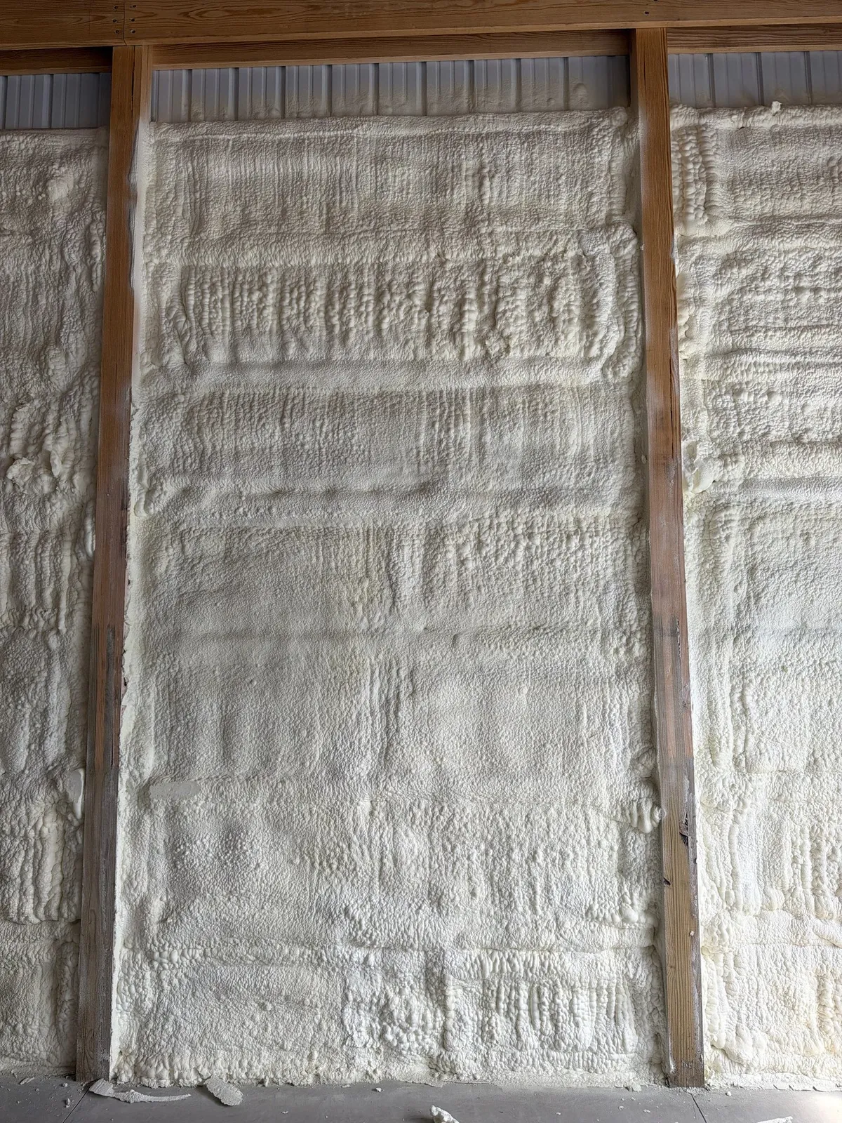 Closed cell spray foam sealing a wall cavity against moisture and drafts