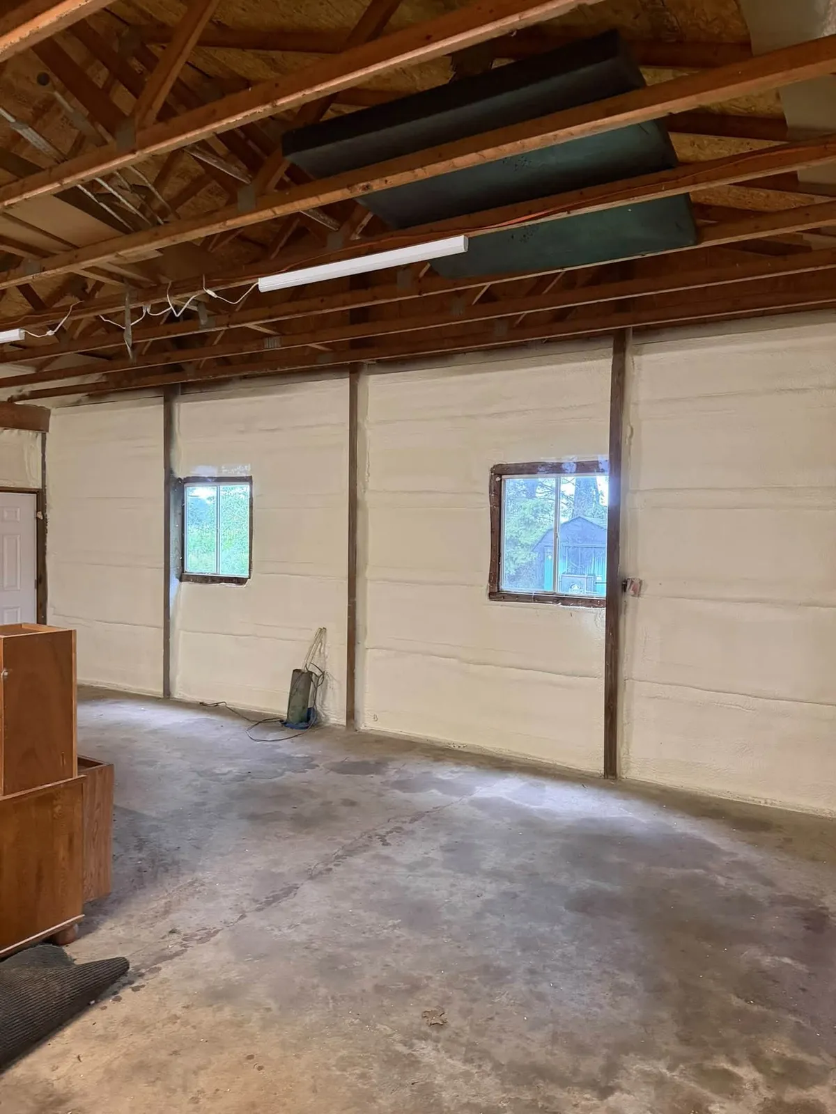 Smooth closed cell spray foam on the walls of a garage in Homer, Michigan