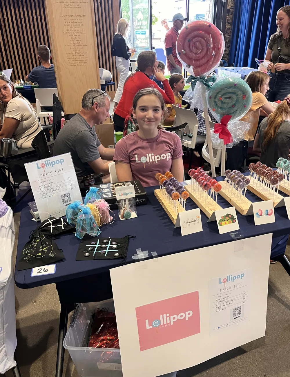A young entrepreneur smiling while making a sale at the Children's Business Fair
