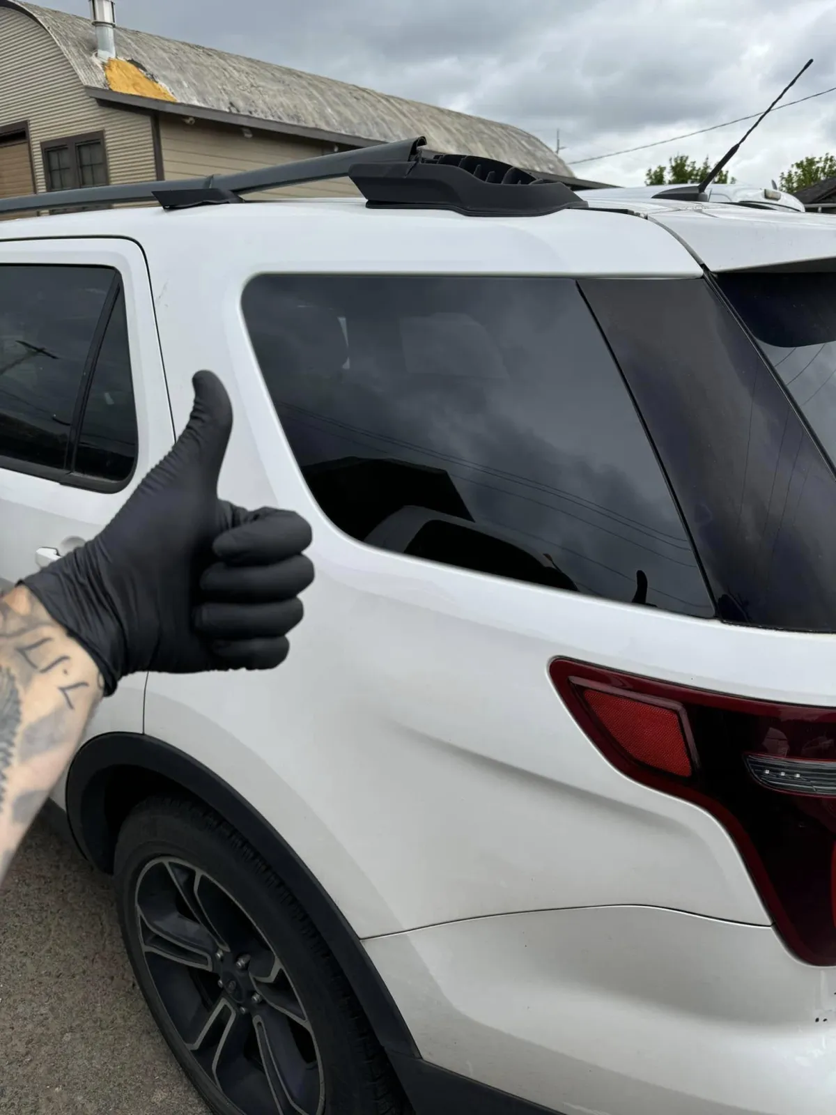 a dog sitting in the drivers seat of a red car